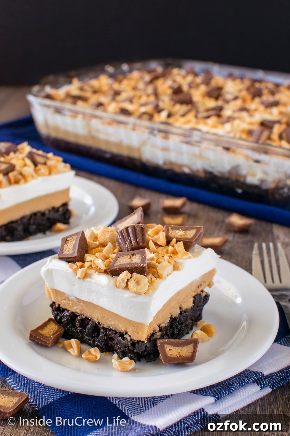 Peanut Butter Brownie Layered Dessert: Decadent No-Bake Treat 4 Squares of a layered peanut butter dessert on white plates.