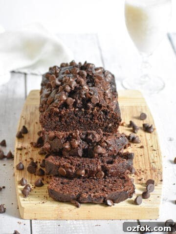 The death by chocolate zucchini bread is on a wooden cutting board