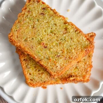 Moist Zucchini Bread Made with Self-Rising Flour 14 Two slices of zucchini bread with self rising flour are on a fluted plate.