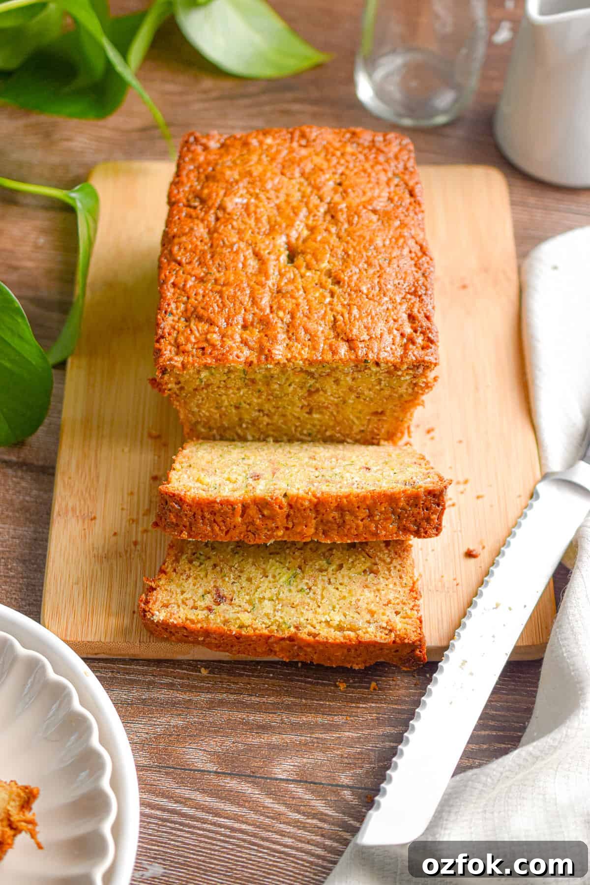 Moist Zucchini Bread Made with Self-Rising Flour 9 The zucchini bread with self rising flour is on a cutting board with two slices cut off the loaf.