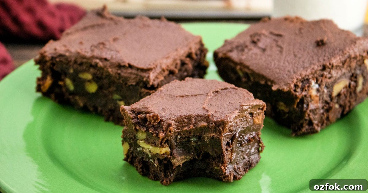 three frosted brownies with walnuts