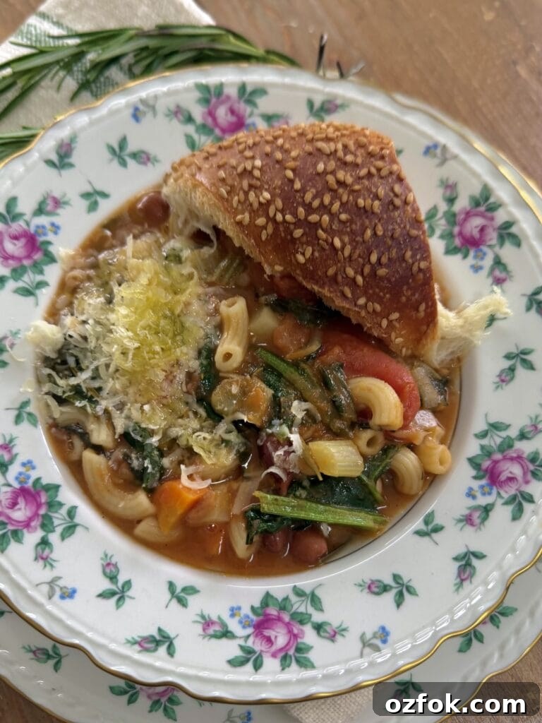 Classic Italian Minestrone Soup Recipe — Hearty Vegetable Stew 11 Bowl of classic minestrone in decorative china soup bowl with piece of Italian bread.
