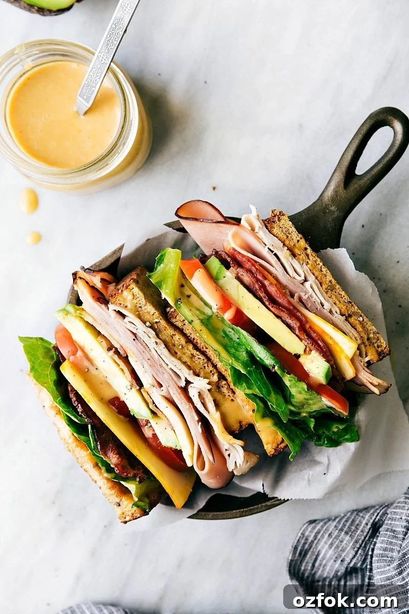 The club sandwich recipe sliced in half to show the different layers.