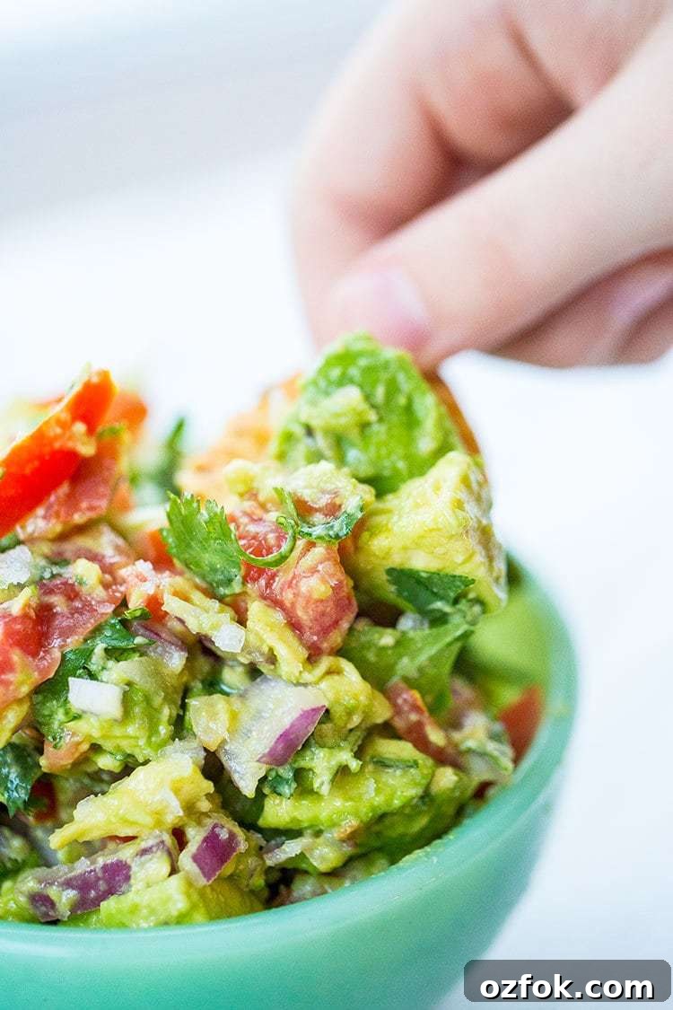 Chunky Homemade Guacamole — Low-Carb Recipe 3 Digging into the Low Carb Homemade Guacamole