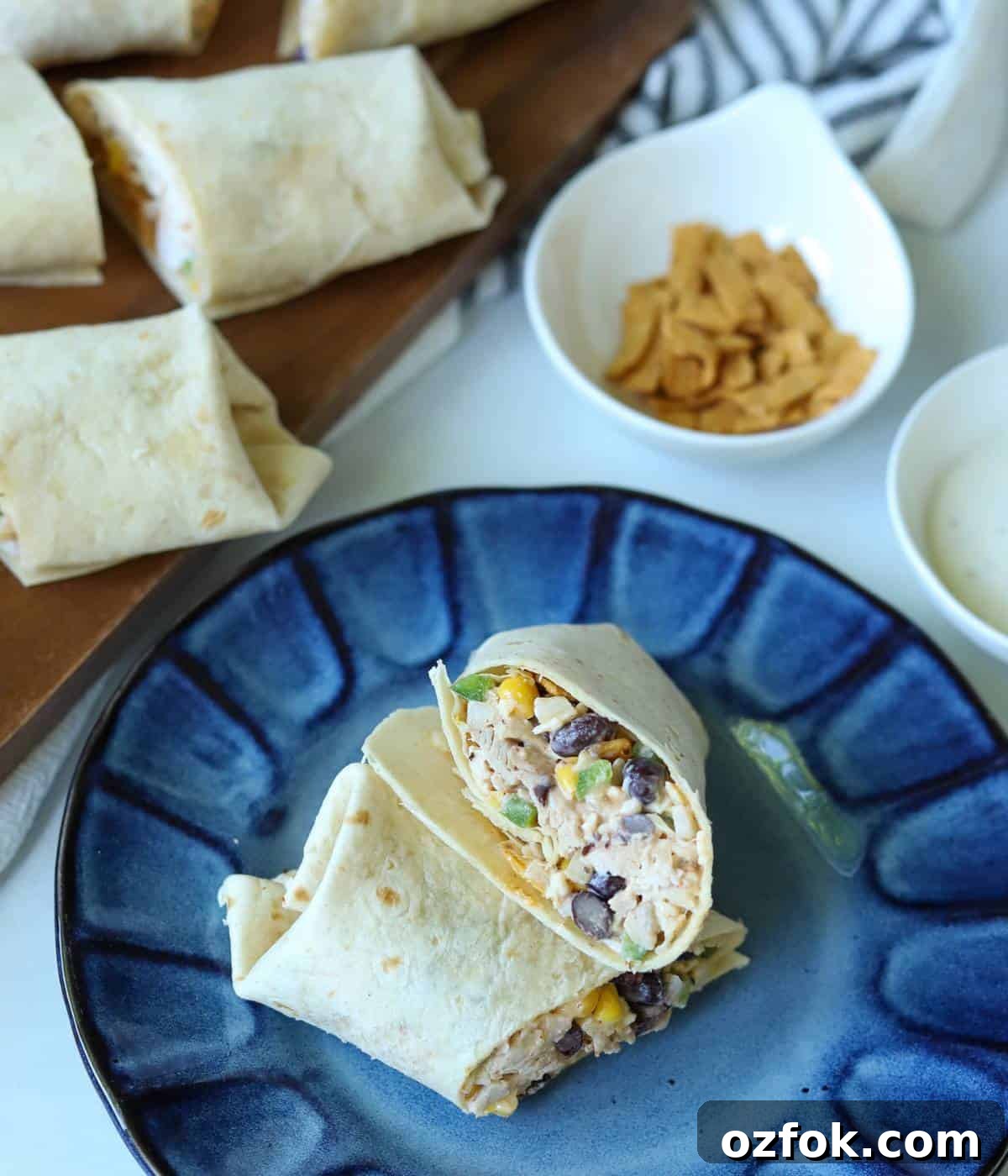 12 Quick Weeknight Dinners Made with Rotisserie Chicken 3 Southwest Chicken Wrap on plate sliced in half.