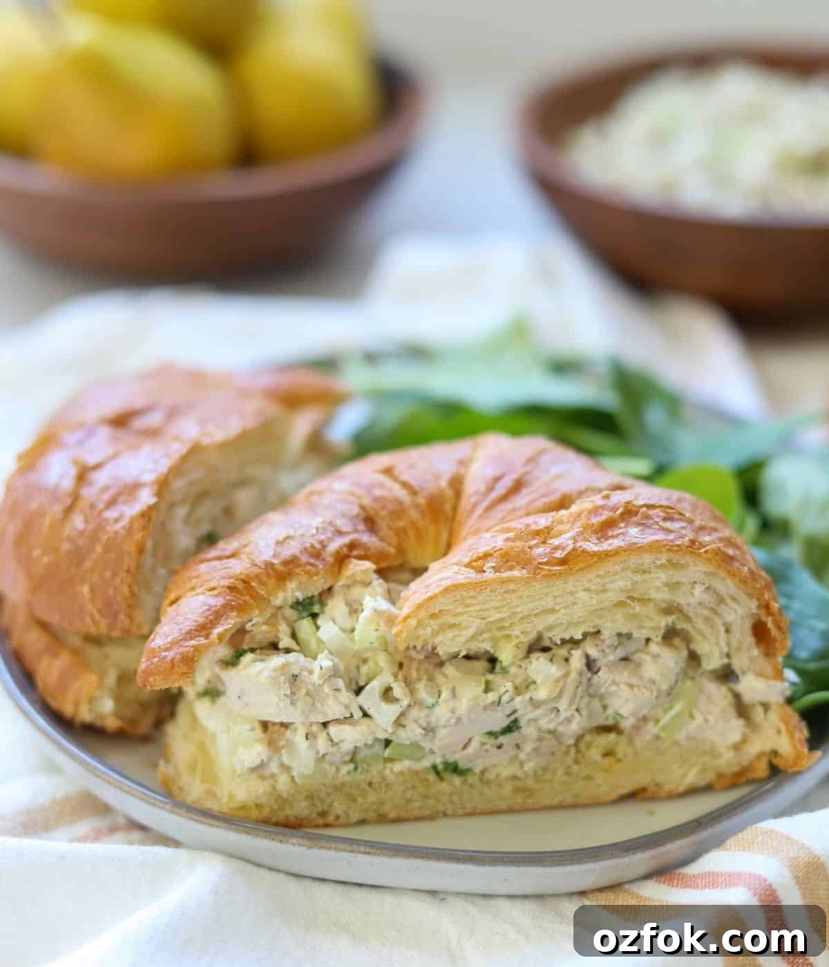 12 Quick Weeknight Dinners Made with Rotisserie Chicken 5 Chicken salad croissant cut in half on a plate