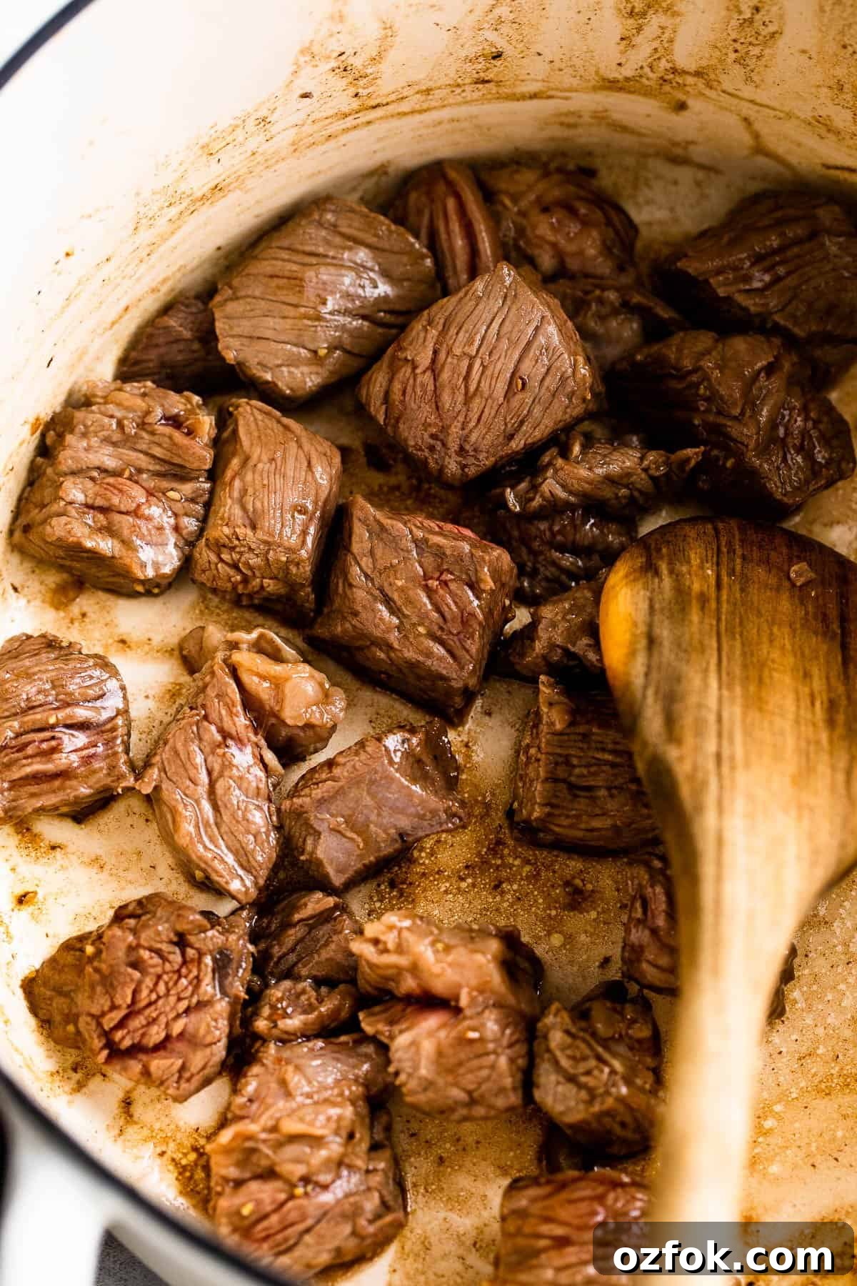 Brown the beef. sauteeing cubed beef for stew