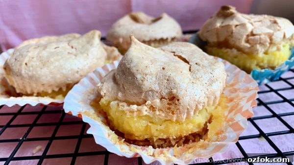 Vanilla Wafer Meringue Pie Cups Vanilla Wafer meringue Pie Cups sitting on a metal cooling rack with a pink background.