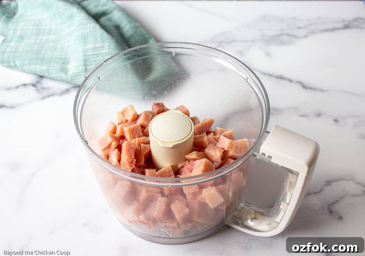 Classic Creamy Ham Salad Recipe for Sandwiches and Dips 4 Chopped ham in a food processor bowl.