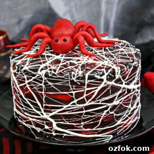 Red Velvet Cake with Marshmallow Spiderweb for Halloween 4 Close up of Red Velvet Marshmallow Spiderweb Cake on a black cake stand.