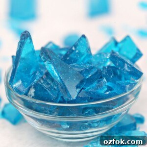 Red Velvet Cake with Marshmallow Spiderweb for Halloween 3 Blue rock candy in a glass bowl.