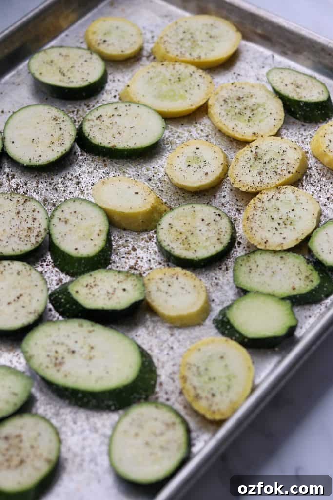 Grilled Summer Squash Smørrebrød with Basil Mayo 3 Zucchini and summer squash slices on a baking sheet