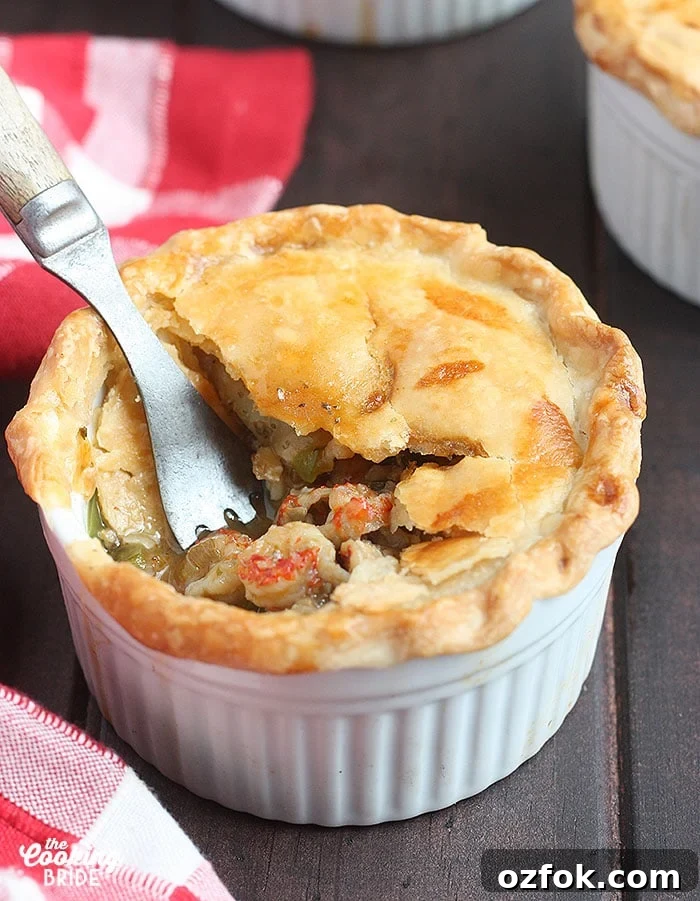 Authentic Cajun Crawfish Pie Recipe: Southern Comfort Dish 7 metal fork taking a bite out of a baked crawfish pie