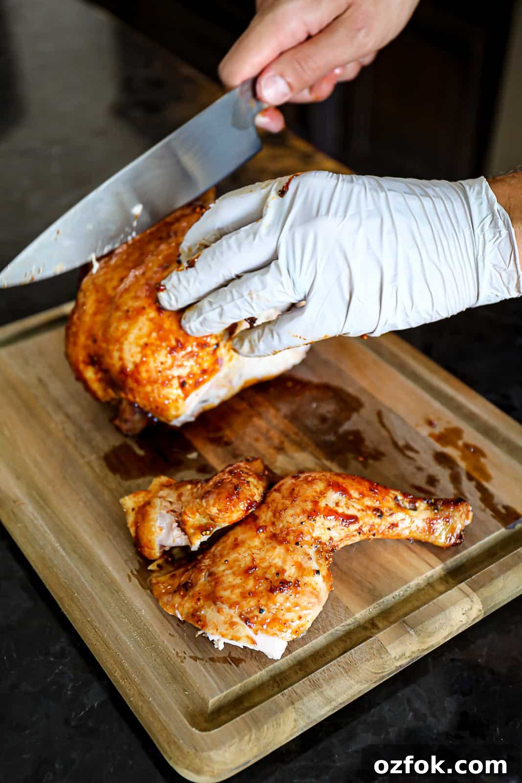 Pellet Smoker Beer-Can Chicken Recipe for Juicy, Crispy Skin 8 Carving Traeger Smoker Beer Can Chicken With BBQ Sauce On A Cutting Board
