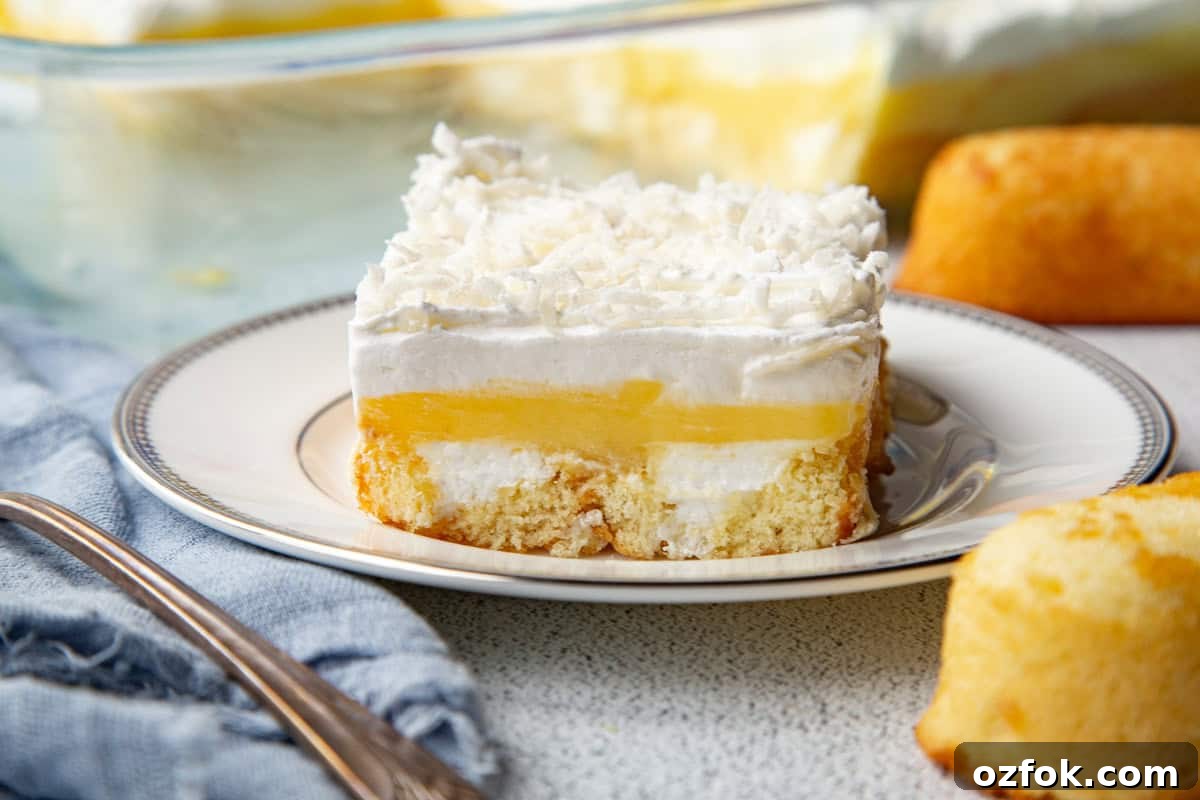 Creamy Twinkie Layer Cake Recipe You’ll Love 8 slice of layered twinkie cake on a white plate.