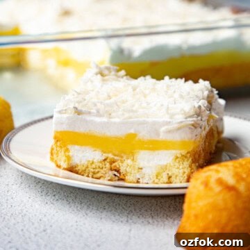 Creamy Twinkie Layer Cake Recipe You’ll Love 9 slice of twinkie cake on a white plate, next to a whole twinkie.