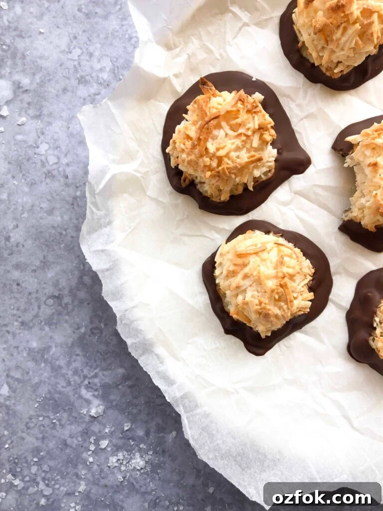 A plate of chocolate dipped coconut macaroons.