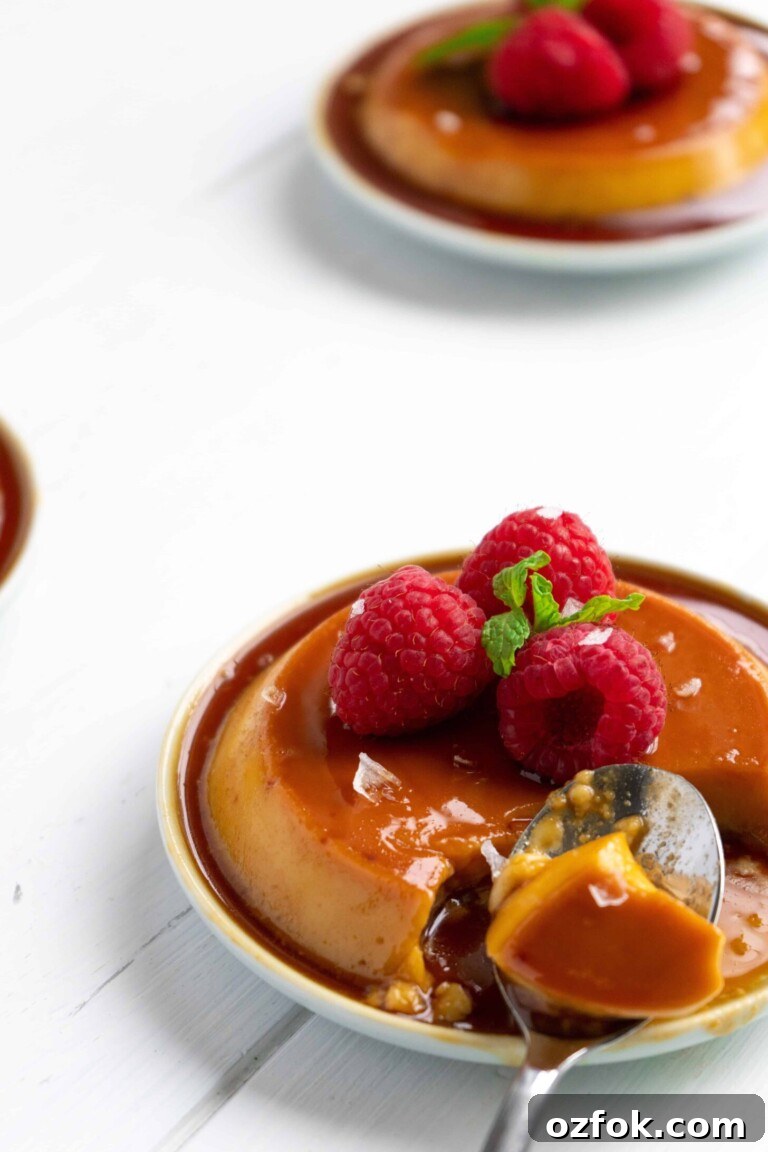 Puerto Rican Salted Coconut Flan on small plates with raspberries.