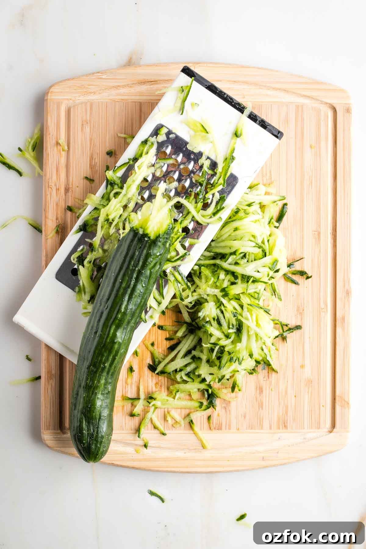 Dairy-Free Tzatziki Sauce: Authentic Vegan Greek Recipe 5 Box grater, shredding a cucumber.
