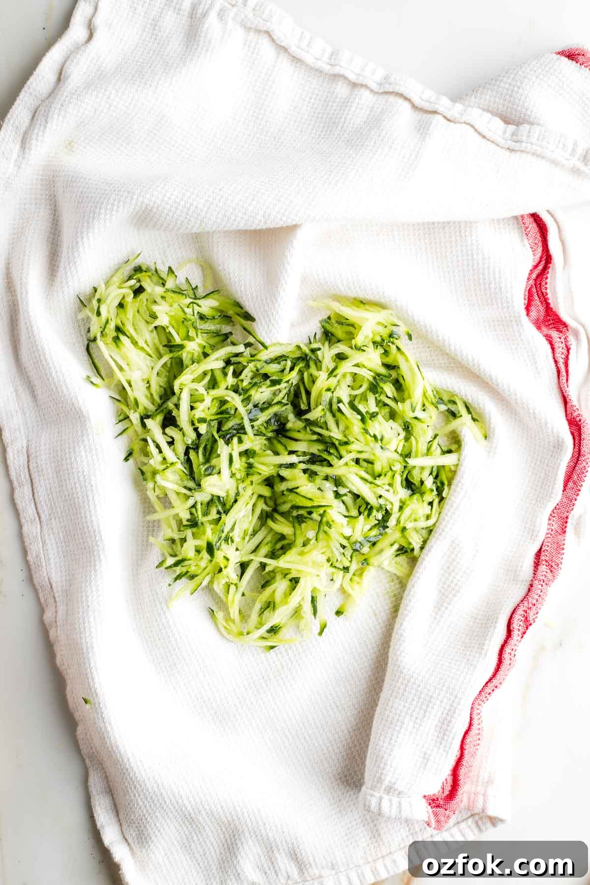Dairy-Free Tzatziki Sauce: Authentic Vegan Greek Recipe 6 Grated cucumber on a dish towel.