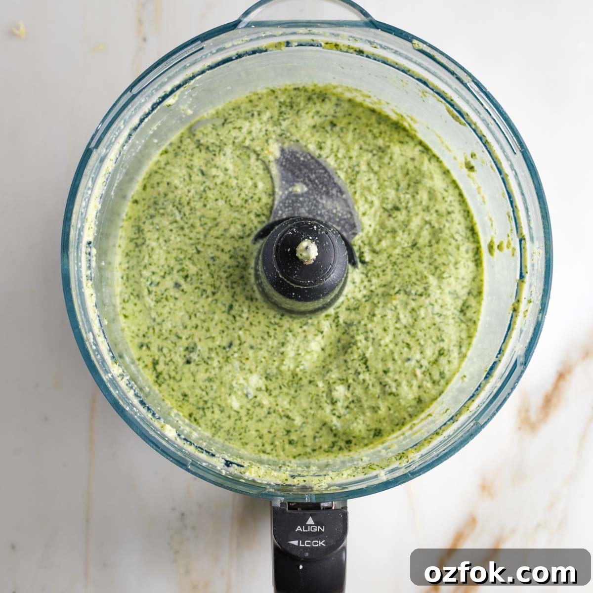 Dairy-Free Tzatziki Sauce: Authentic Vegan Greek Recipe 8 Food processor bowl with green creamy vegan tzatziki sauce.