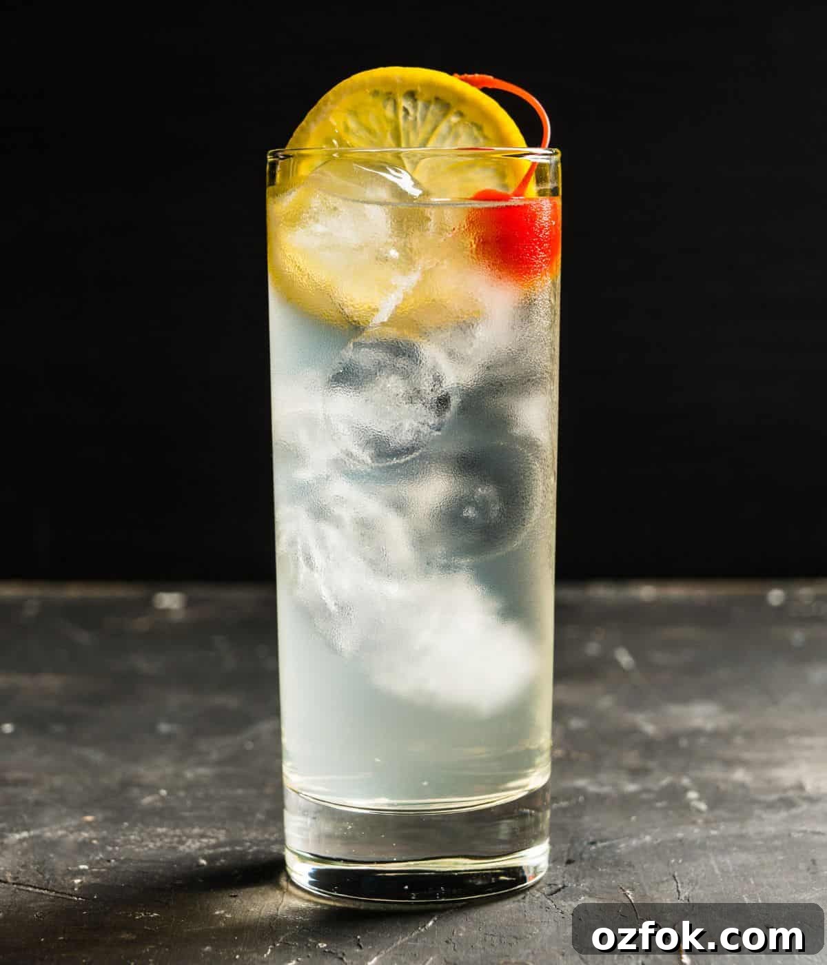 Guide to Cocktail Glasses: Styles, Uses, and Cocktail Pairings 15 A clear drink in a collins glass.