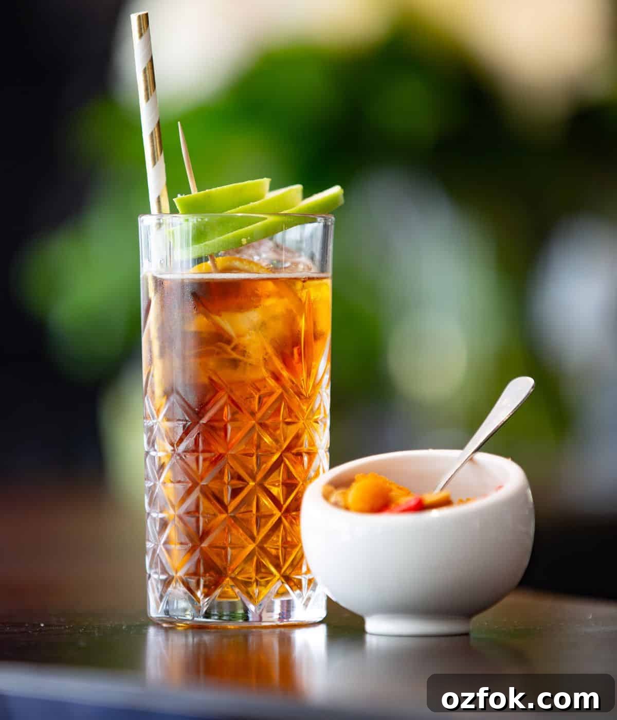 Guide to Cocktail Glasses: Styles, Uses, and Cocktail Pairings 6 A highball glass with a cocktail and garnish.