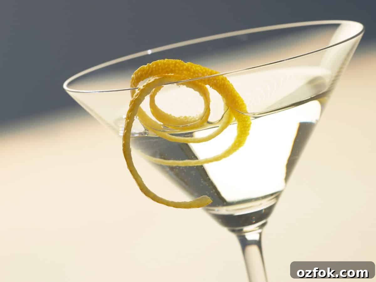 Guide to Cocktail Glasses: Styles, Uses, and Cocktail Pairings 10 A martini with lemon twist.