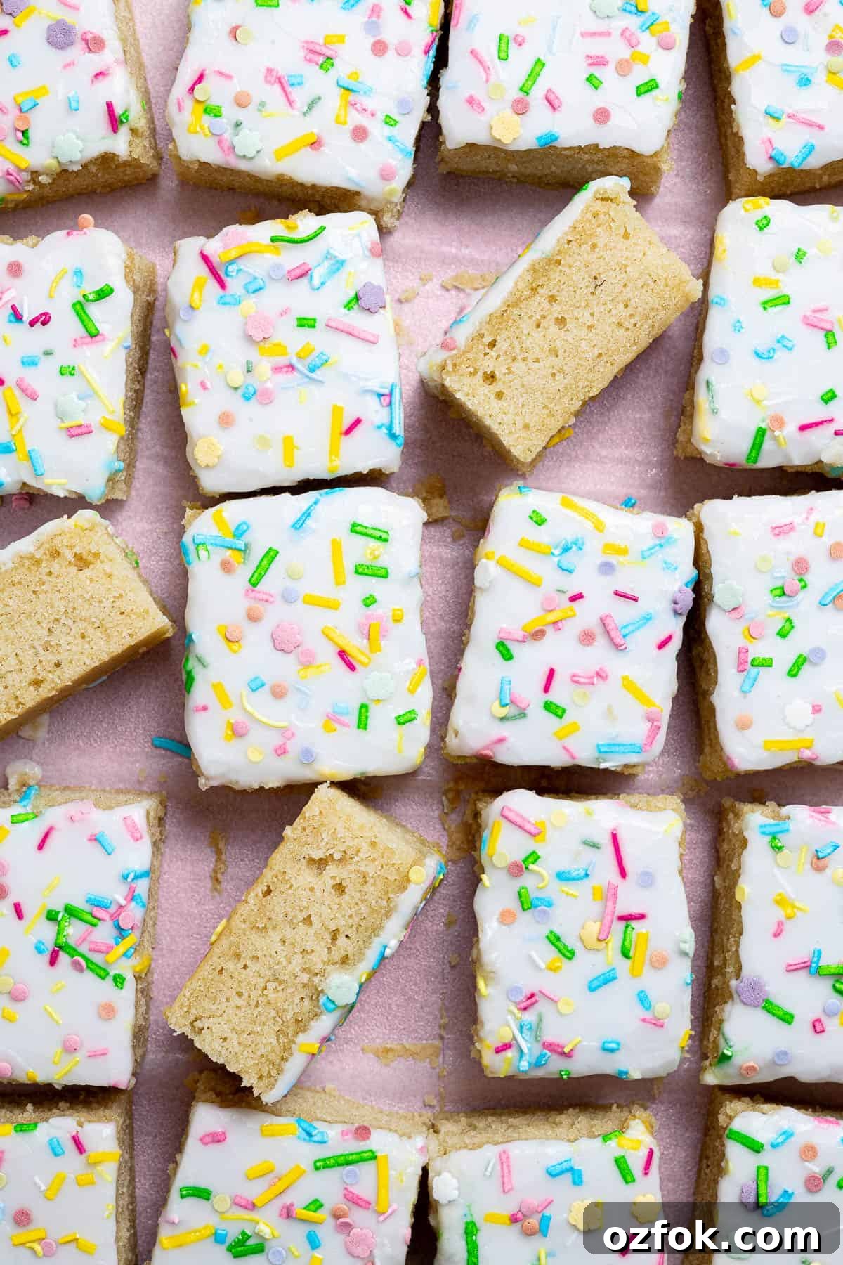 Vegan Birthday Cake Ideas for School Parties 13 Squares of vegan school cake on a sheet of baking paper.