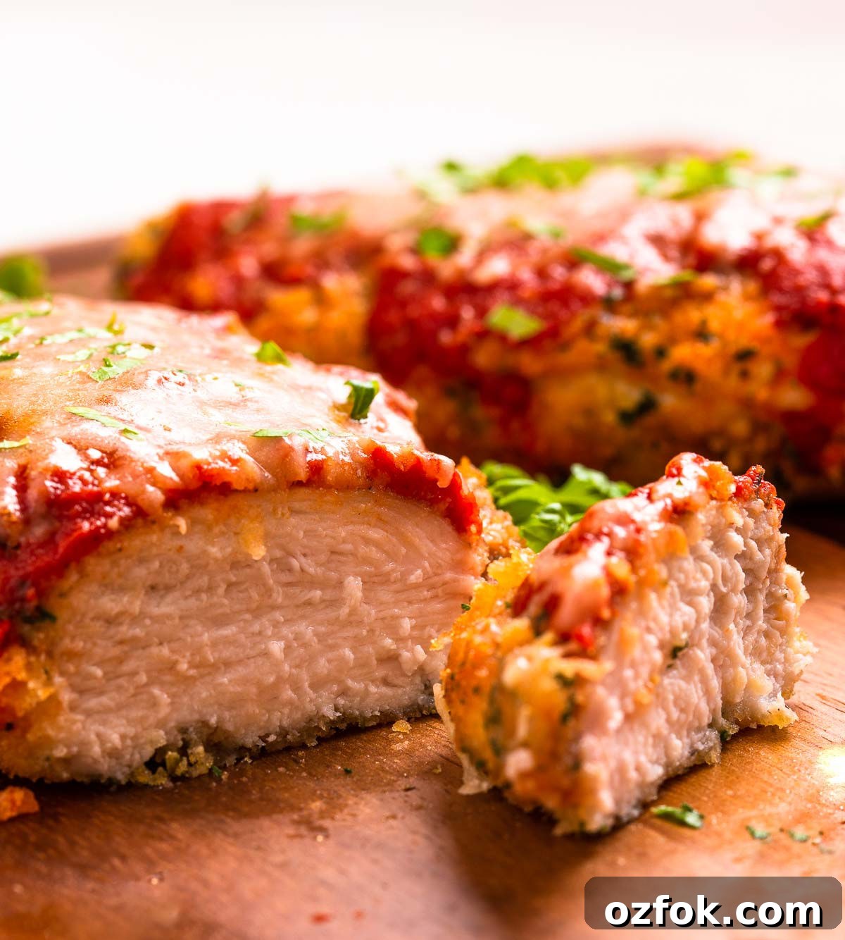 Keto Air Fryer Chicken Parmesan Recipe for Crispy Low-Carb Dinner 3 Two low carb breaded and air-fried chicken parmesan cutlets with marinara sauce and cheese.