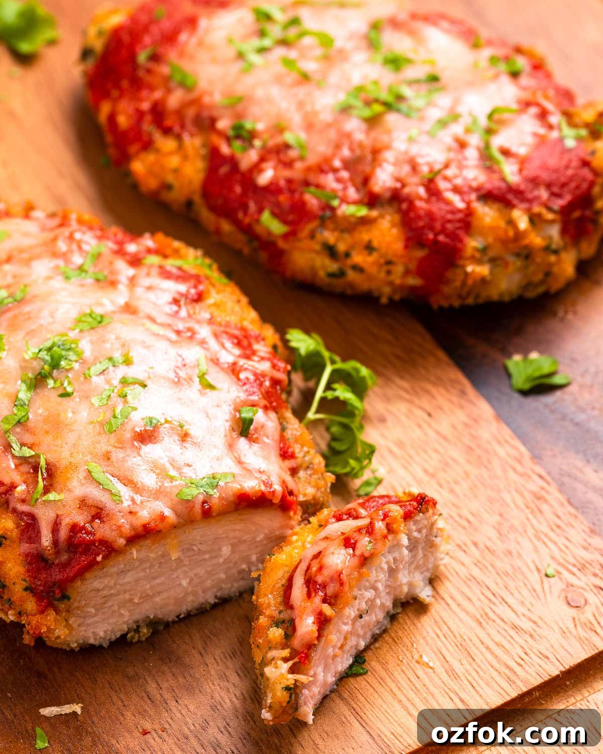 Keto Air Fryer Chicken Parmesan Recipe for Crispy Low-Carb Dinner 5 Slicing into a keto chicken parmesan cutlet.