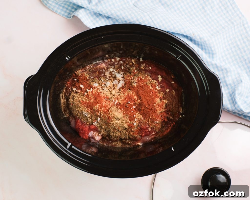 Slow Cooker Chicken Tikka Masala Recipe for Tender, Creamy Curry 5 Chicken thighs, diced onion and spices in a slow cooker
