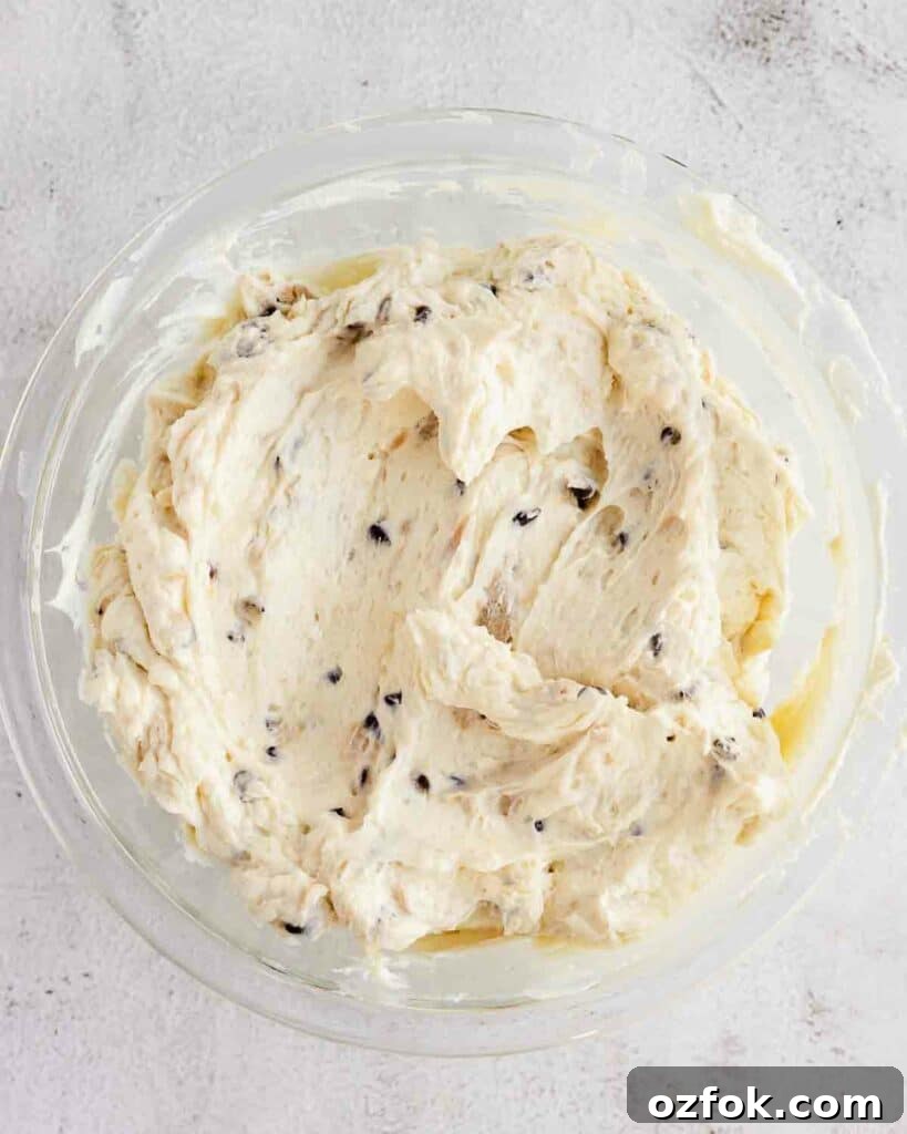 Cookie Dough Fudge Brownie Cake Recipe for Decadent Desserts 10 russian buttercream with chunks of cookie dough and chocolate chips