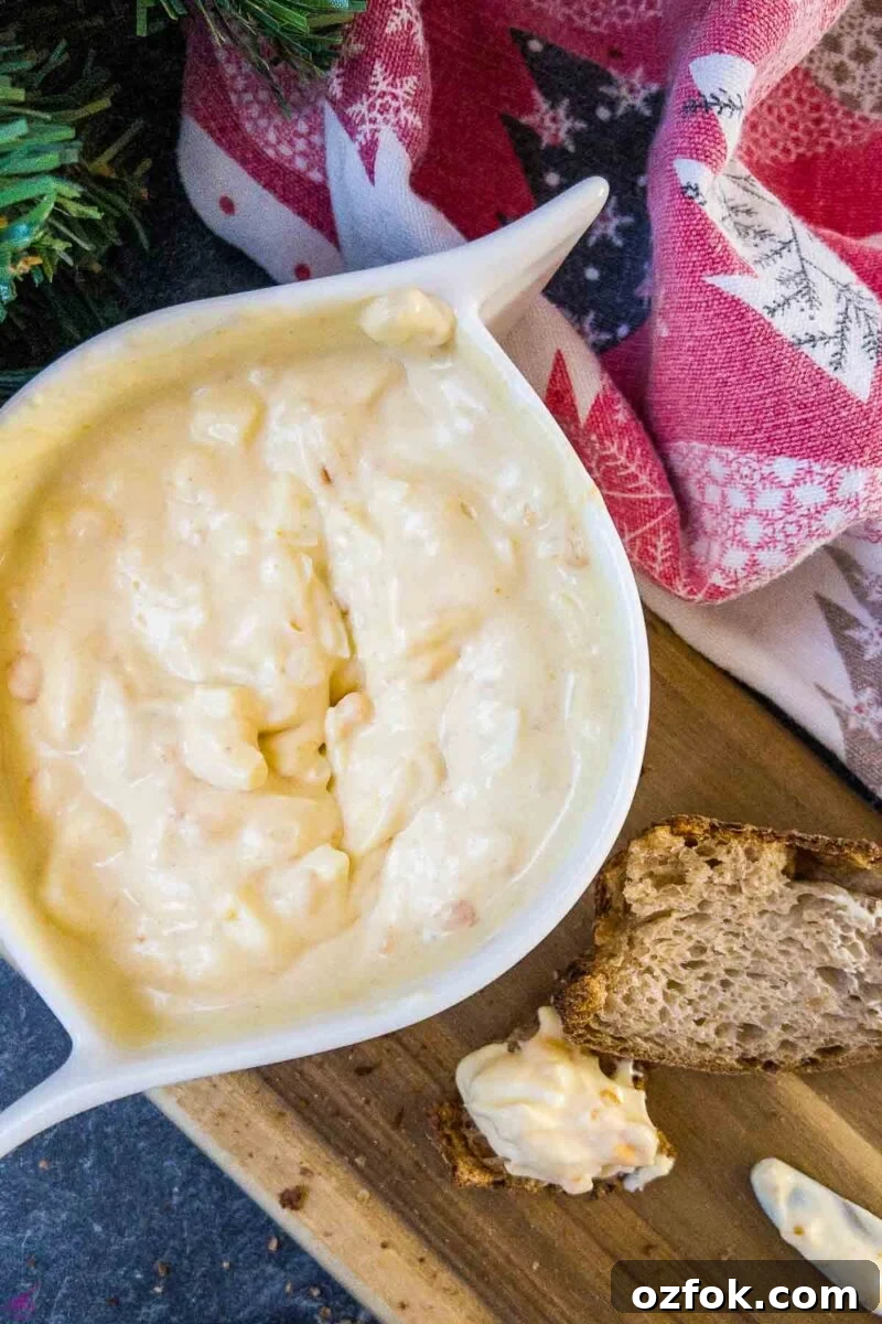 Creamy Classic Egg Salad Recipe for Sandwiches and Lunch 2 White bowl with egg salad spread and coated bread on brown board.
