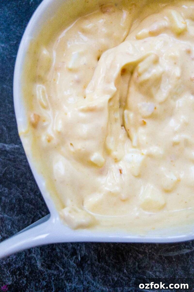 Creamy Classic Egg Salad Recipe for Sandwiches and Lunch 5 White bowl with egg salad spread.