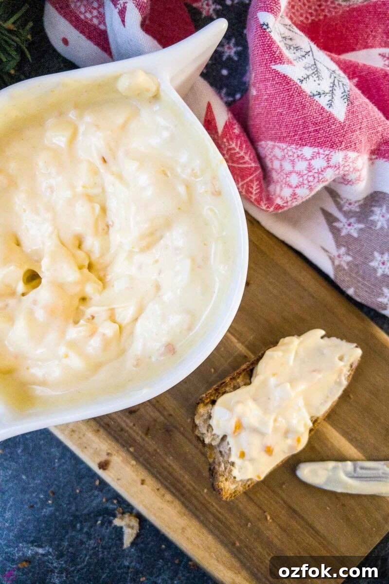 Creamy Classic Egg Salad Recipe for Sandwiches and Lunch 6 White bowl with egg salad spread and coated bread on brown board.