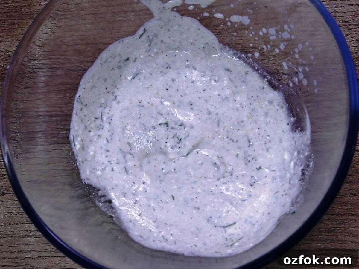 Creamy Greek Yogurt Cucumber Salad with Dill and Lemon 5 greek yogurt dressing for cucumber salad in a bowl.
