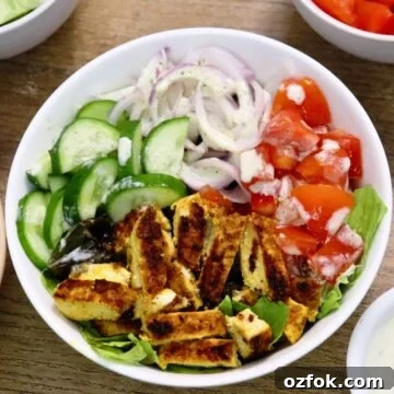 chicken shawarma salad bowl on a brown countertop.