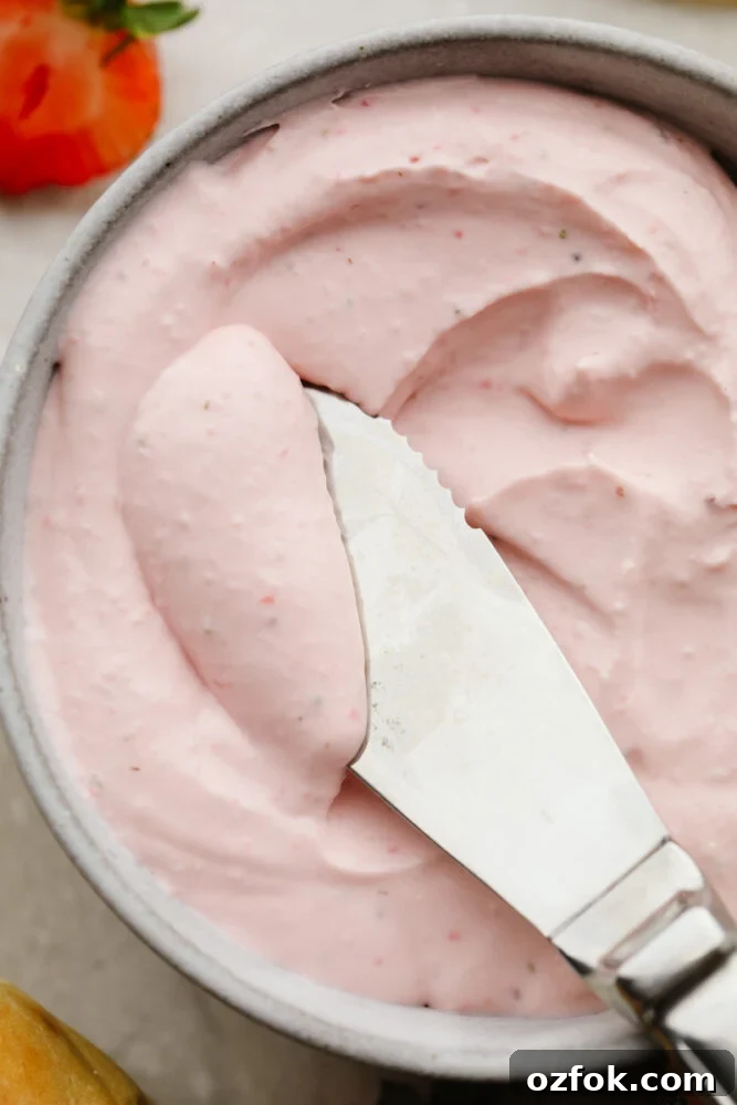 Strawberry cream cheese Cream cheese being served with a butter knife.