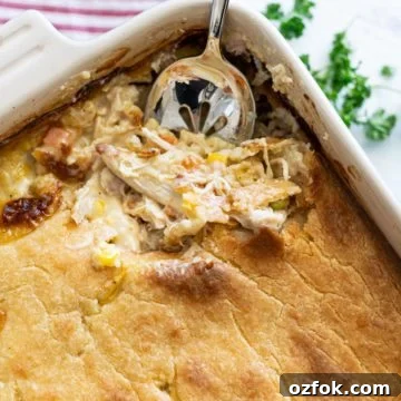 Chicken pot pie casserole with spoon scooping out a serving