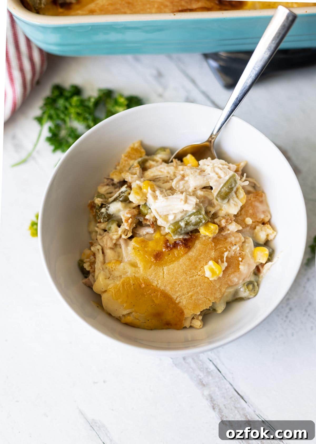 Chicken pot pot in a white bowl with spoon.