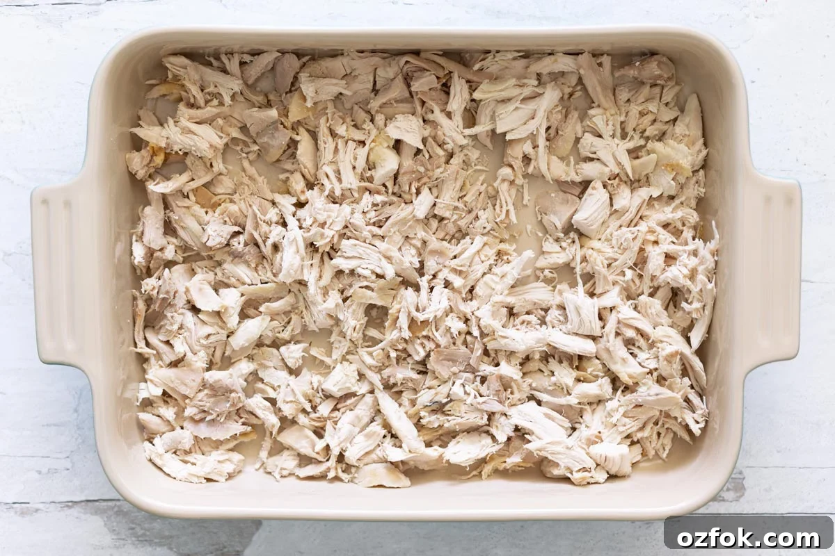 Pyrex dish of shredded chicken.