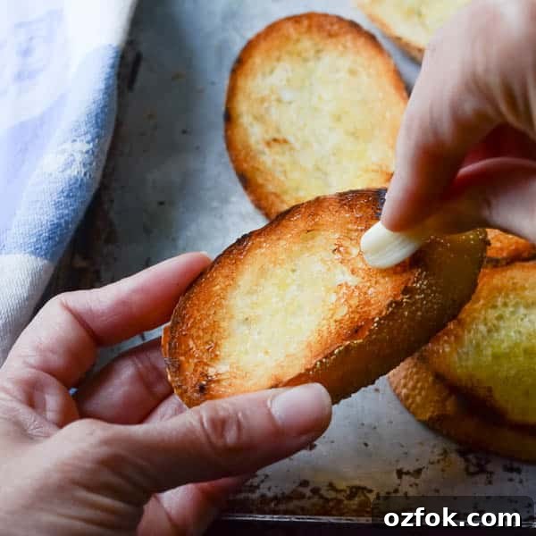 Calamari, Avocado & Grapefruit Bruschetta Recipe 6 I am rubbing grilled bread with garlic.
