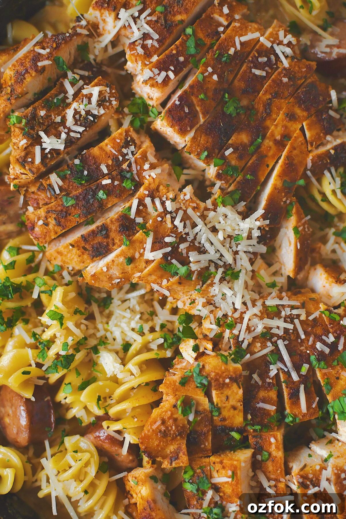 Cajun Chicken Alfredo finished in the pan with chicken on top.