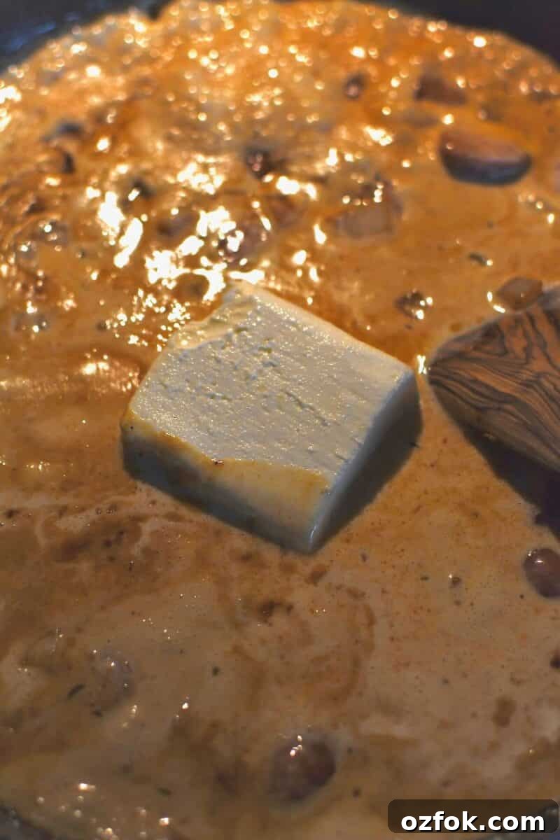 Cream and cream cheese added to the pan.