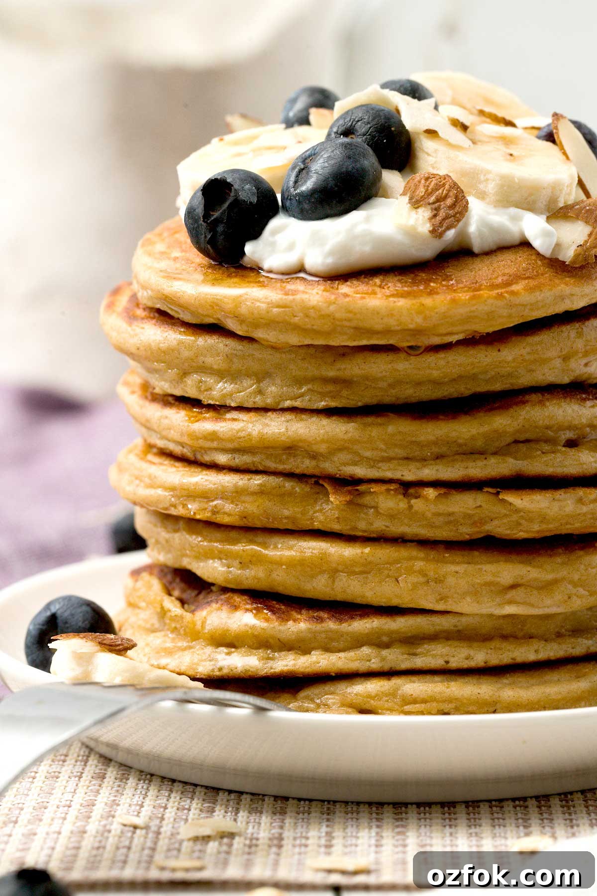Fluffy Gluten-Free Oat Flour Protein Pancakes 4 A close-up view of a stack of gluten-free protein pancakes.