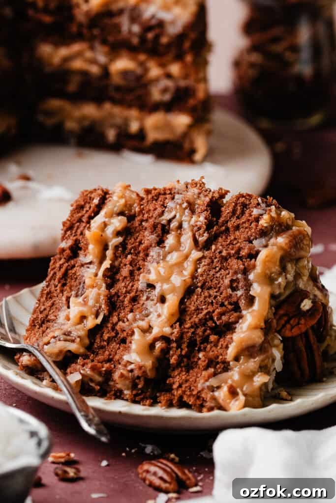 Ultimate German Chocolate Cake Recipe for Rich, Layered Flavor 12 A slice of the cake laying on a cake plate.