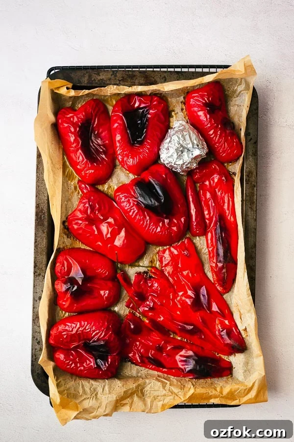 Homemade Rose Harissa Paste Recipe for Vibrant Flavor 5 Roasted red peppers in a tray.