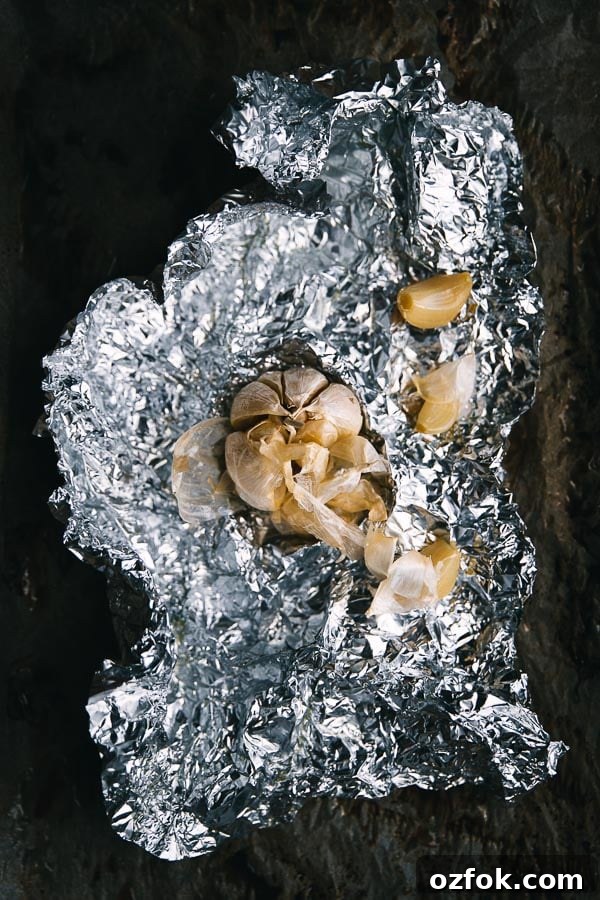 Homemade Rose Harissa Paste Recipe for Vibrant Flavor 7 Roast garlic wrapped in foil.