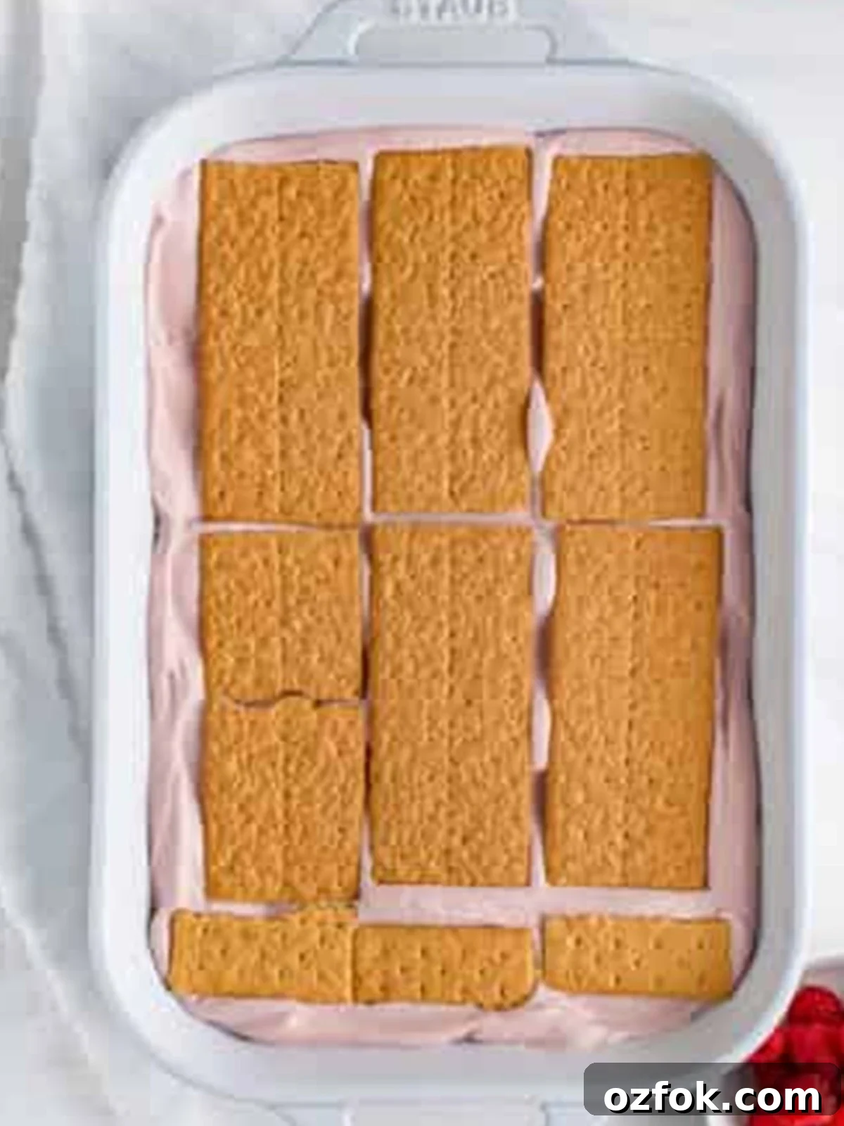 No-Bake Raspberry Icebox Cake Recipe for Summer Parties 12 Third graham cracker layer placed over the pink cream for Raspberry Icebox Cake.